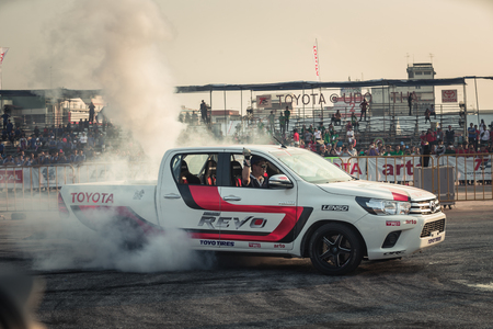 October 18, 2015:Techapol Toyingchareon the driver of  Toyota Hilux Revo perform drifting contest on the track between driver from Thailand and Japan at the event Toyota Motor Sport show at Udon Thani, Thailand with  smoke of the burnout tiresのeditorial素材
