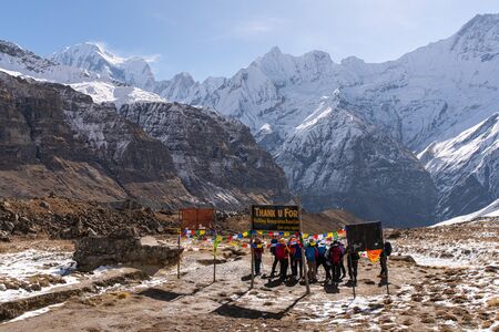 himalayas annapurna base camp trekking sign with traveller taking pictureのeditorial素材