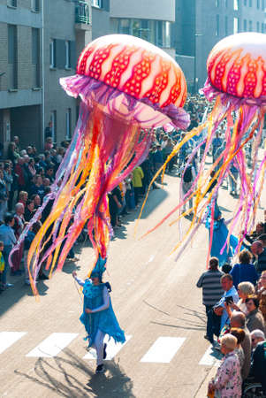 Genk, Belgium - May 1st 2019: Participants of annual O-parade. Young women are steering giant floating jellyfishes.のeditorial素材
