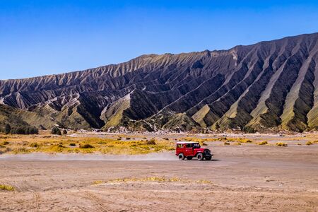 The tourist driving red 4wd at Mount Bromoの写真素材