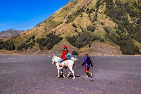 Mount Bromo volcano, Indonesia.JULY 27 ,2019:Tourists ride horses to view the scenery and go to the Bromo crater.のeditorial素材