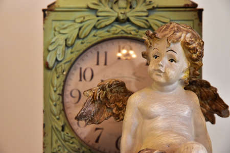 Old clocks and Angel figurinesの写真素材