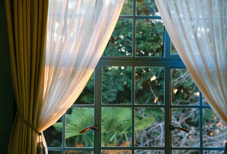 The setting sun illuminates the windowの写真素材