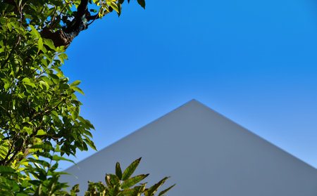 A triangular roof and blue sky
