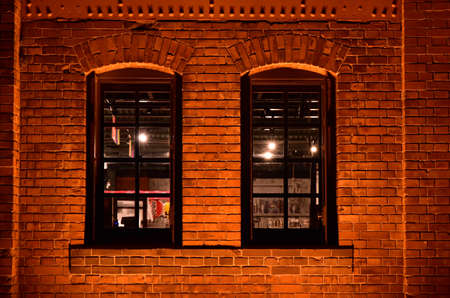 Windows of the brick building at nightの写真素材