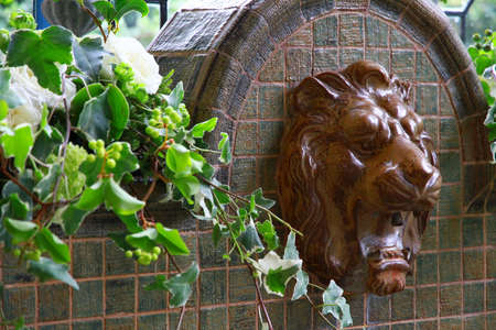 Lion water taps and green sceneryの写真素材