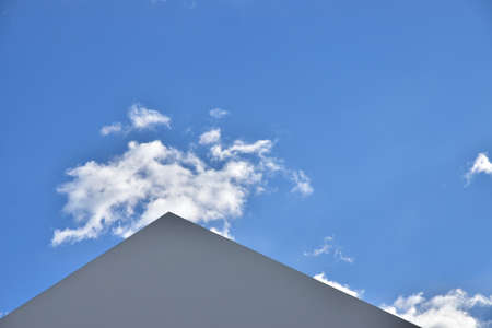 Views of the clear blue sky and the triangular roofの写真素材