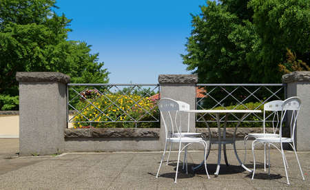 Park on a sunny table and chairsの写真素材