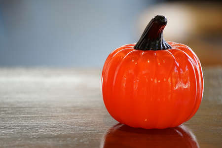 Table on the orange color of pumpkin figurineの写真素材
