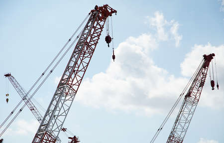 Blue Sky with construction cranes, construction machineryの写真素材