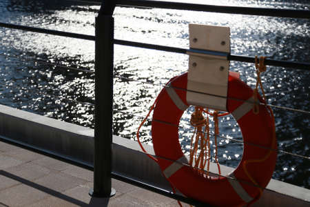 Port of the setting sun illuminates the life buoyの写真素材