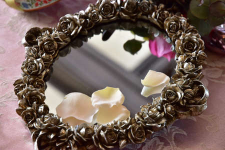 Mirror with floral decoration on the tableの写真素材