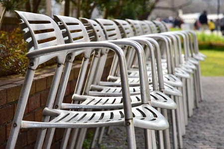 The metal chair which was arranged to one line outdoorsの写真素材