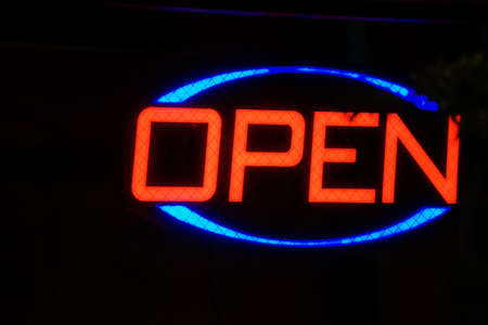 Neon sign of red and blue open lettersの写真素材