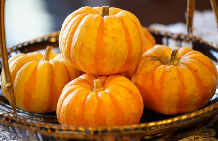 Many orange pumpkins which were piled in the plate