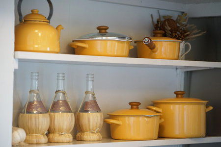 Yellow pan in the shelf of the kitchen