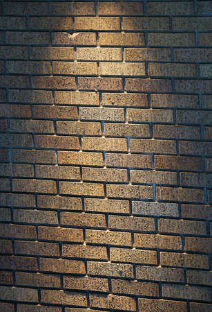 Brick wall of building illuminated by lightの写真素材