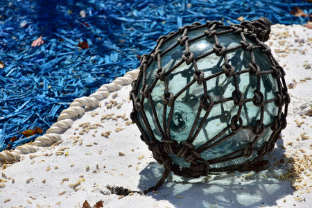 Scene of the net which hung over a ball of the round glass in the background of blue and the whiteの写真素材