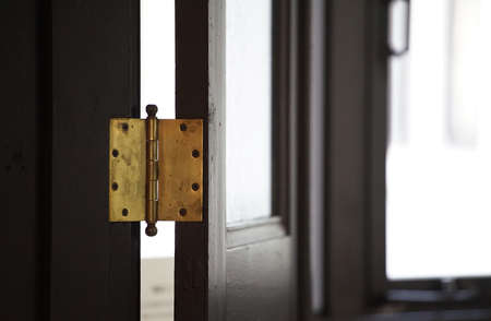 Wooden door and hinge of the entrance of the roomの写真素材