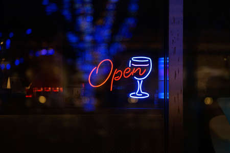 Neon sign to see from the glass of the night windowの写真素材