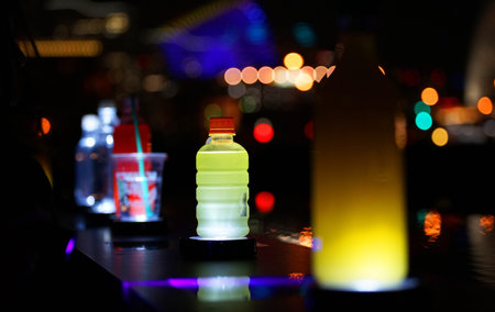 The drink which was lighted up by the colorful light on the table