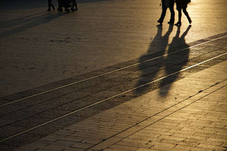 Evening view of the shadow of a person walking in the squareの写真素材