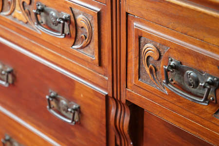 Wooden furniture with drawers with handles in the roomの写真素材