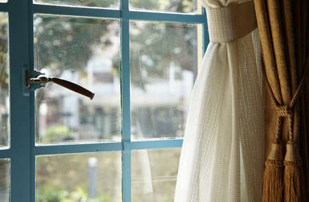 Window and curtains of a room on a sunny dayの写真素材