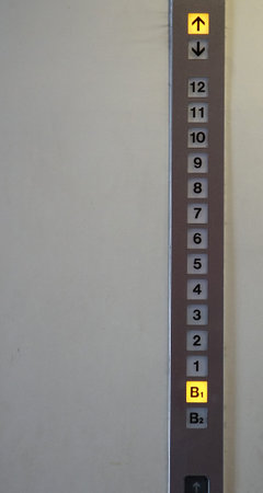 Numbers on the destination floor display on the elevator wall
