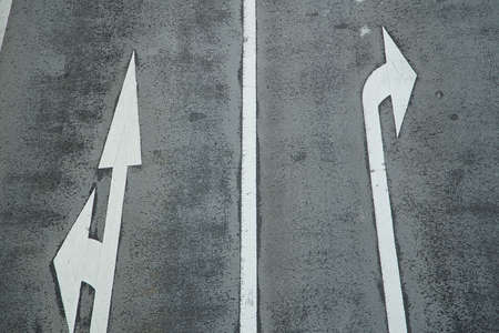 Asphalt road surface markings with destination direction arrowsの写真素材