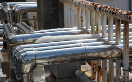 Many silvery metal air conditioning pipes outdoors