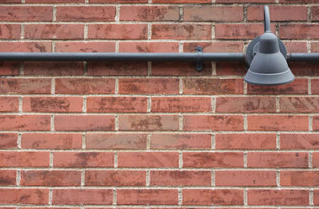 The building`s brown brick walls and light fixturesの写真素材