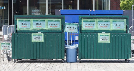 Separate garbage dumpsters placed outside in Japan
