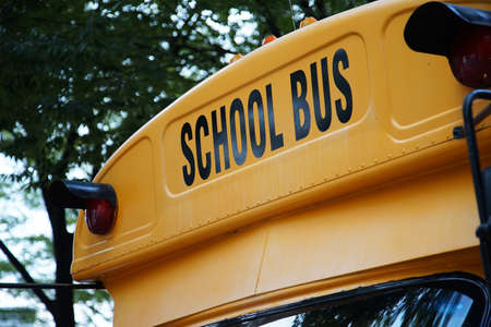 A yellow vehicle with the words `School Bus` written on itの写真素材