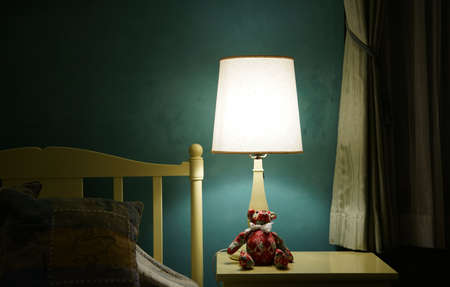 The light from the wall lamp in the bedroom at nightの写真素材