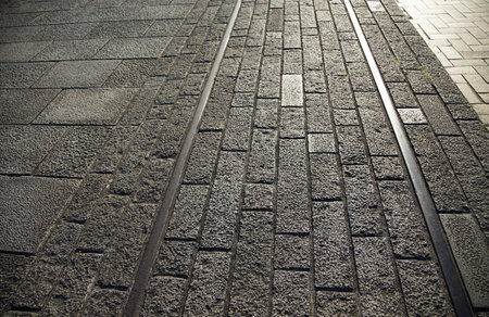 A cobblestone walkway on the ruins of an abandoned railroad, illuminated by the setting sunの写真素材