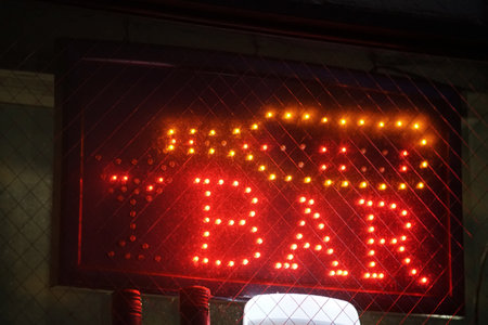 Night view of the red electric sign of the bar in the storefrontの写真素材