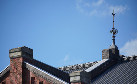 Lightning rod on roof of building on a clear blue sky dayの写真素材