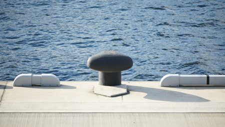 Mooring posts on the harbor quay on a sunny day