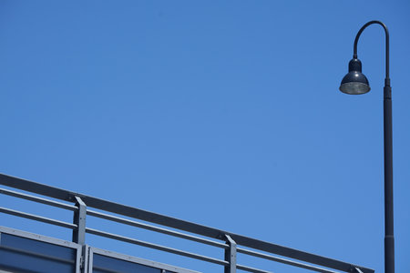 A pedestrian bridge and streetlight of the day of the blue skyの写真素材