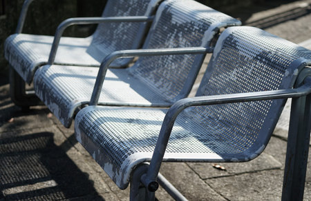 Empty metal chairs in a public parkの写真素材