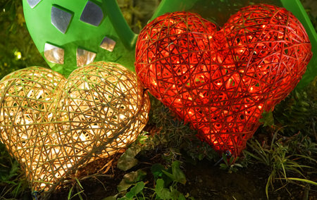 Valentine's day background with red and green hearts on grassの写真素材