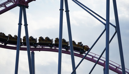 Rollercoaster in the amusement park with blue sky in the backgroundの写真素材