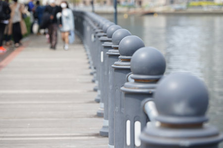 Sidewalks and fences along the river in the cityの写真素材