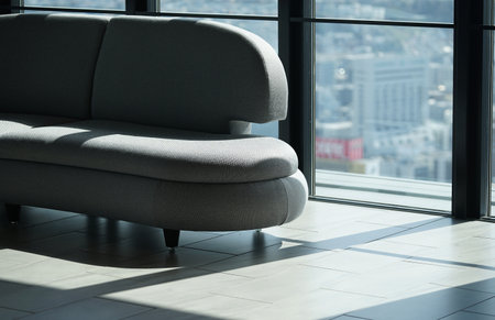 Modern living room interior with sofa and panoramic city view backgroundの写真素材