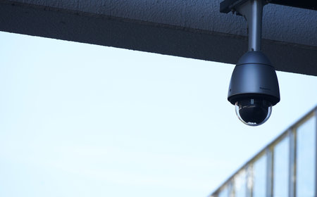 CCTV security camera or surveillance system on the roof of building.の写真素材