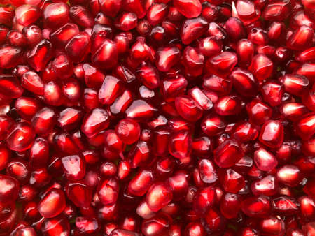 Juicy pomegranate garnet grains as a textureの写真素材