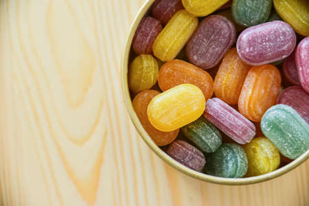 Colorful lollipops on wooden backgroundの写真素材