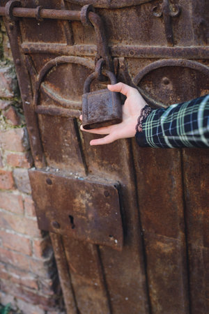 hand holds a lock on the door is closed