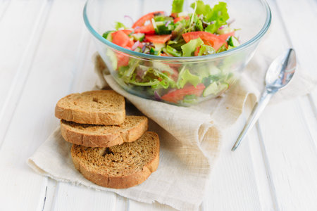 taste of vegetarian summer concept, salad of lettuce leaf, tomato, cucumber, onion, oregano with...